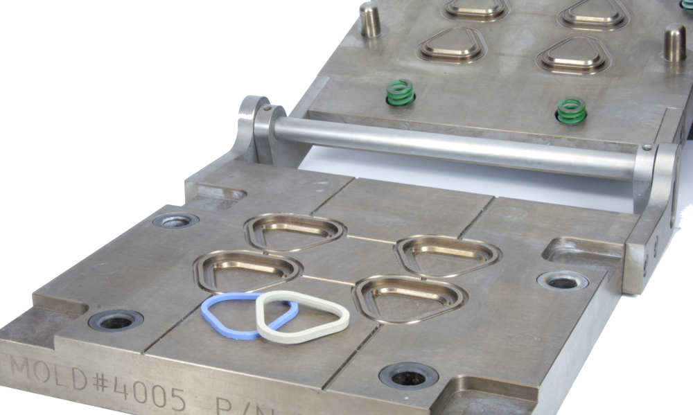 Steel compression mold with 2 solid silicone triangular parts on it