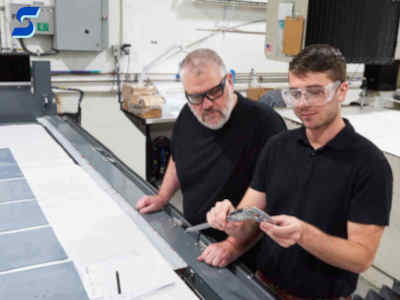 Engineer and operator measuring the size of a part