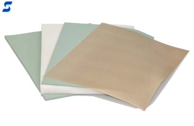 Assortment of swatches of r10400 green sponge, white bf1000 foam, and beige ptfe film