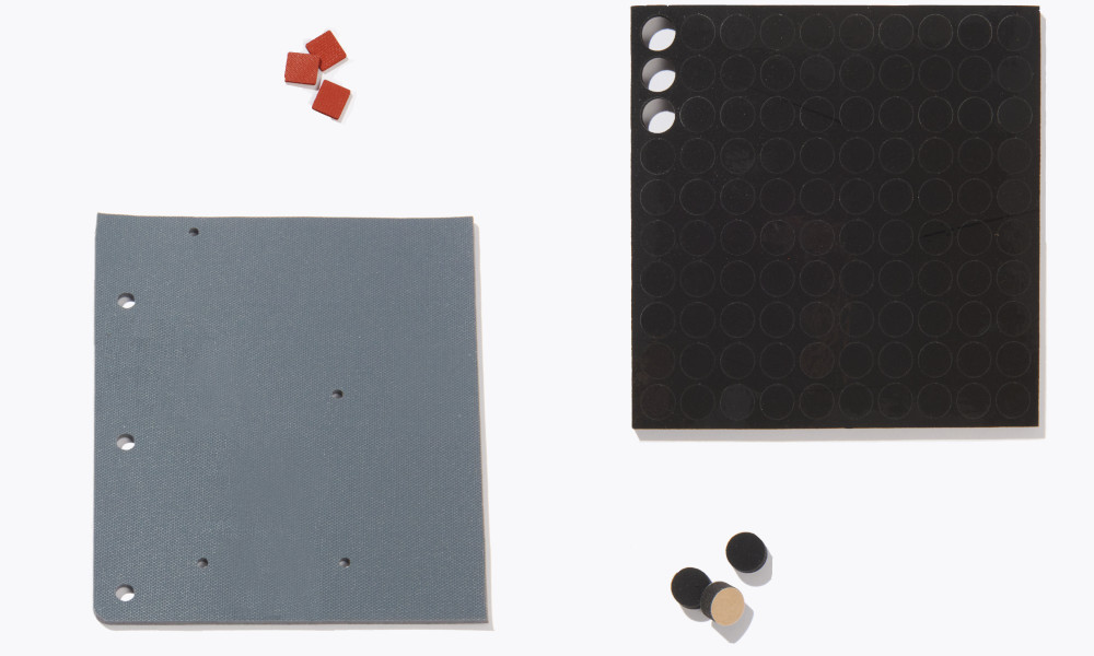 Small black cylindircal and red squre silicond pads shown next to large gray and black pads