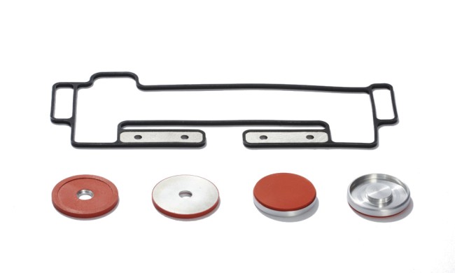 Black and red solid silicone window gaskets and pucks with metal insert molded pieces 
