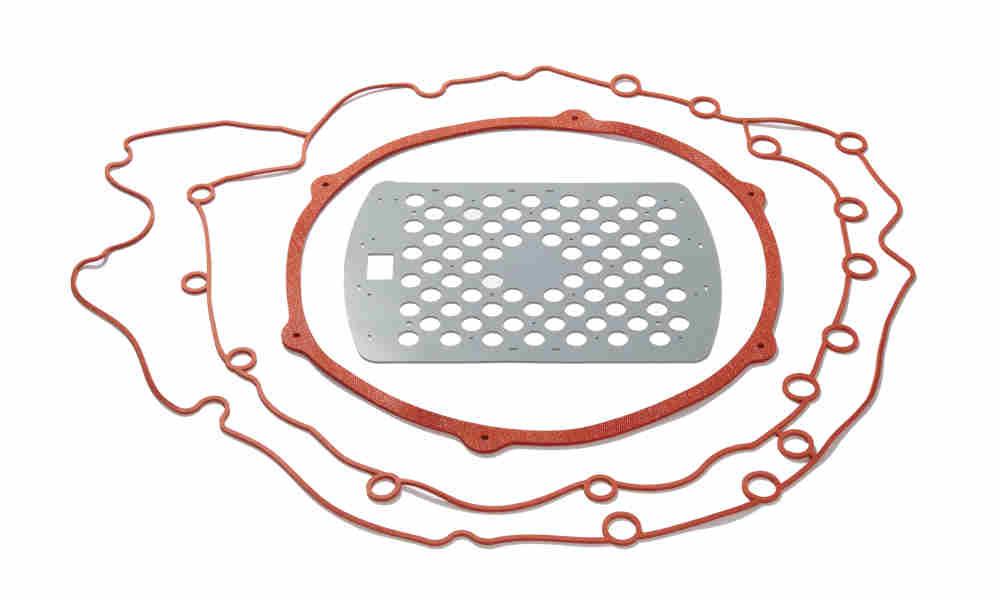 Oversized red compression molded solid, and red waterjet cut sponge parts with gray foam Oversized red compression molded solid, and red waterjet cut sponge parts with gray foam