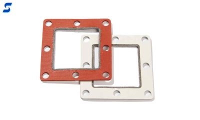 White and red sponge gaskets with monel wrap along the inside edge 
