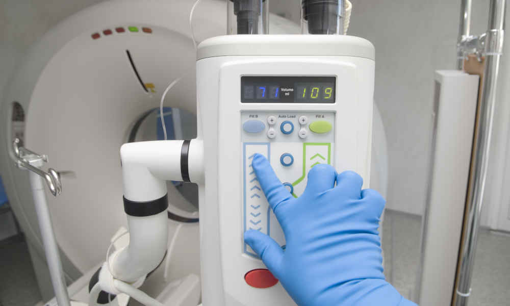 Operator at the control panel of medical diagnostics machine Operator at the control panel of medical diagnostics machine