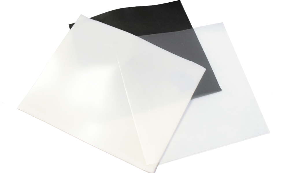 3 swatches of platinum cured fluorosilicone solids in translucent, cream, and black 3 swatches of platinum cured fluorosilicone solids in translucent, cream, and black
