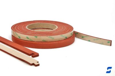 Rolls of red sponge shown with long strips with cutours for UV dovetail bonding
